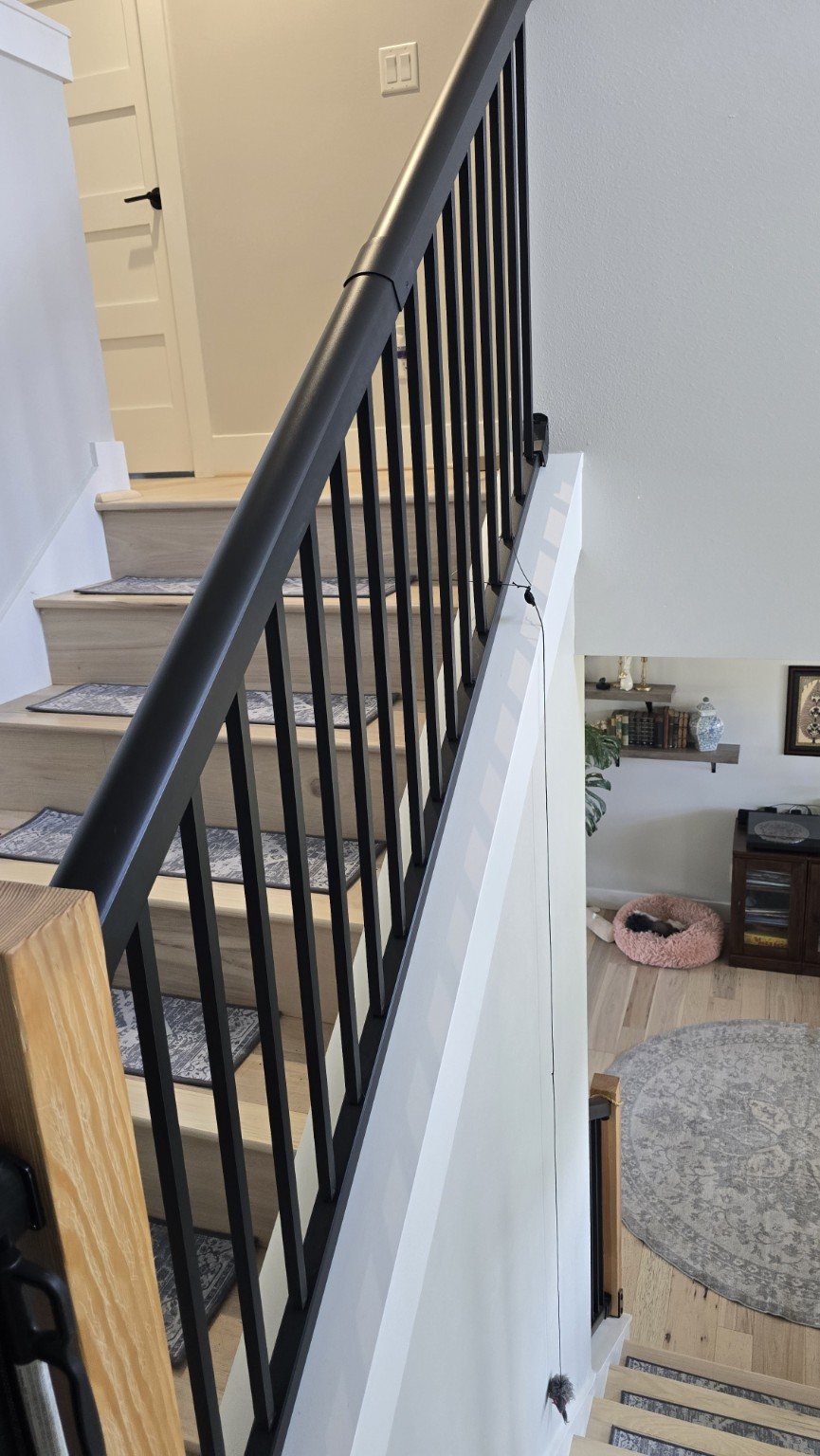Interior stair railing upgrade with black balusters